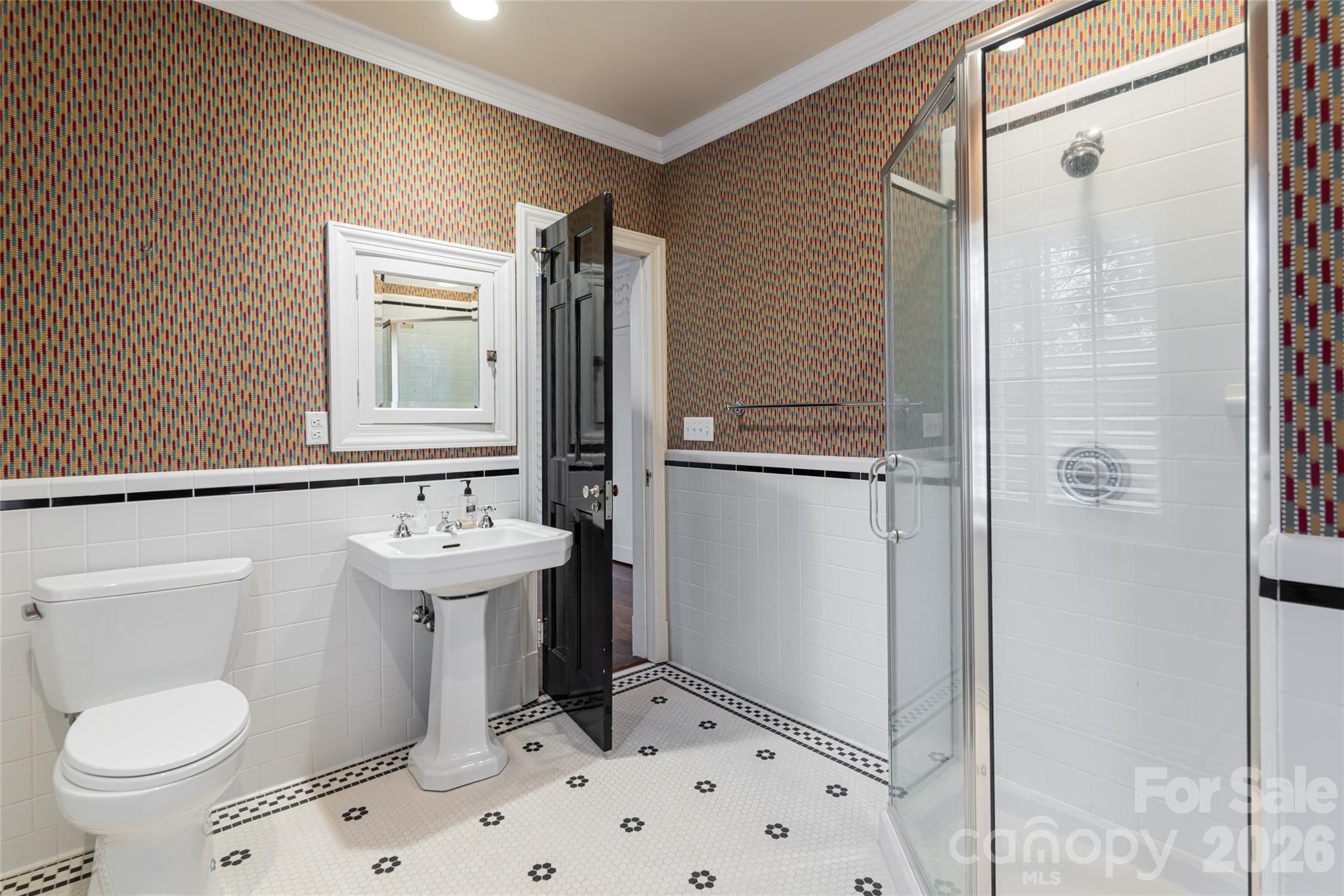 31 Busbee Road Asheville, NC 28803 - Photo 35 of 48 a bathroom with a sink a toilet and shower