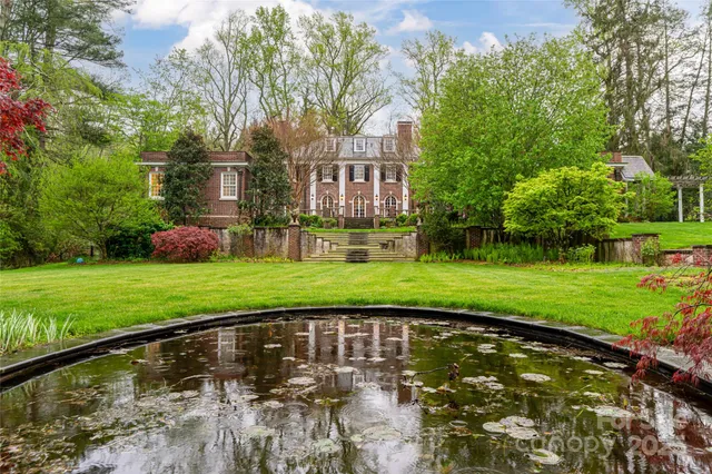 a front view of a brick house with a yard