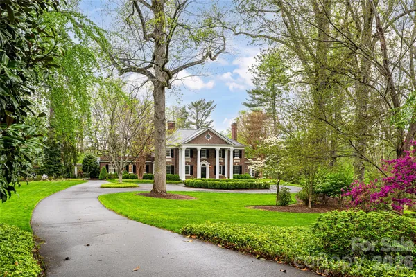 a front view of a brick house with a yard