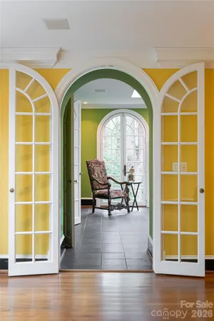 a living room with furniture a fireplace and a floor to ceiling window