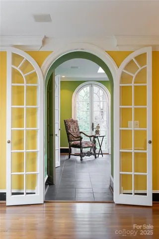 a living room with furniture a fireplace and a floor to ceiling window