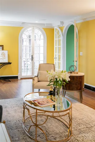 a living room with fireplace furniture and a large window