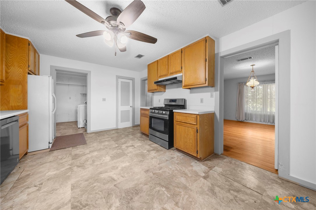 12558 Guyton Road Troy, TX 76579 - Photo 11 of 32 a view of a kitchen with a sink and a refrigerator