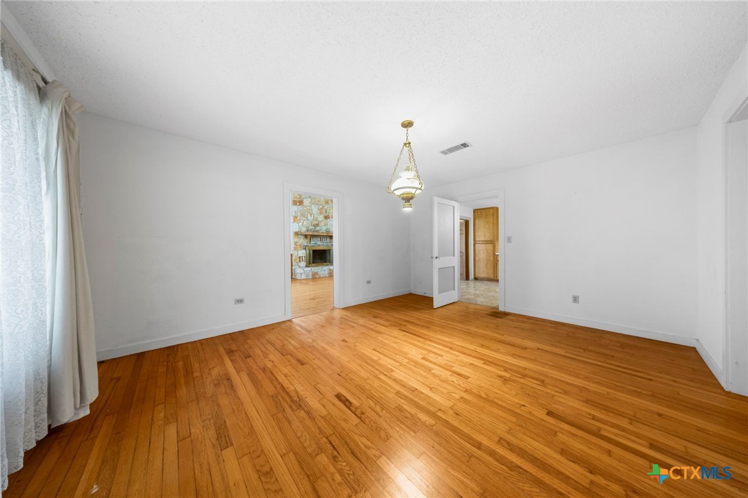 12558 Guyton Road Troy, TX 76579 - Photo 13 of 32 a view of empty room with wooden floor