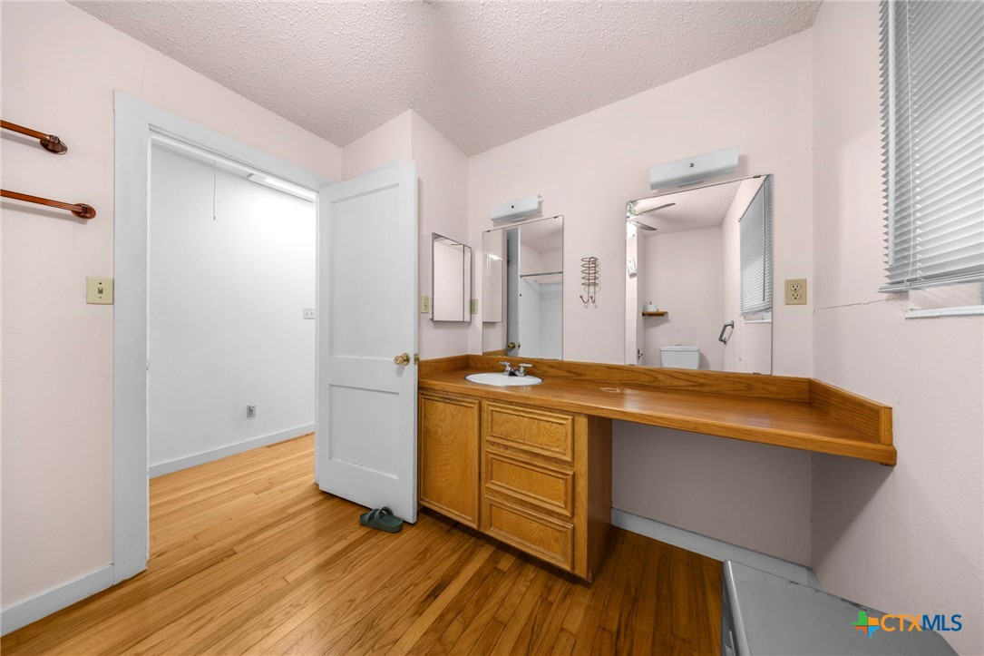 12558 Guyton Road Troy, TX 76579 - Photo 24 of 32 a spacious bathroom with a granite countertop sink and a mirror