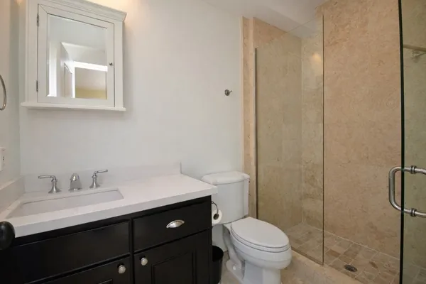 a view of empty room with wooden floor and fireplace