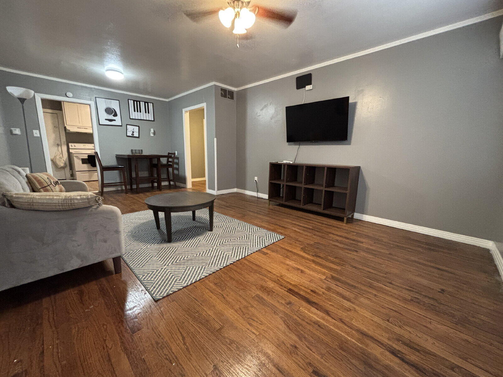 1808 14th Street, Unit 2 Lubbock, TX 79401 - Photo 2 of 8 a living room with furniture and a flat screen tv