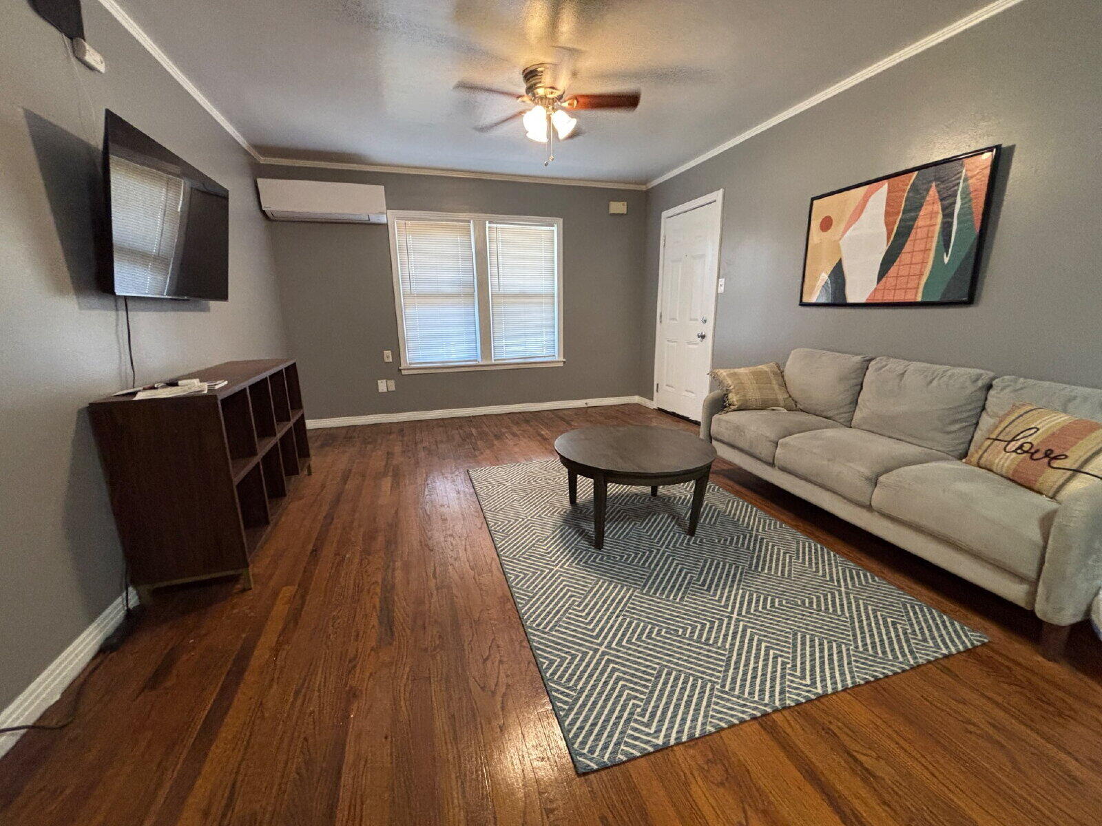 1808 14th Street, Unit 2 Lubbock, TX 79401 - Photo 4 of 8 a living room with furniture and a flat screen tv