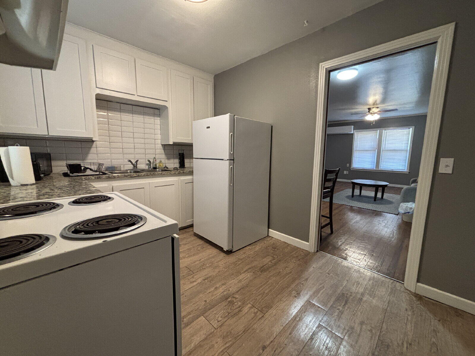 1808 14th Street, Unit 2 Lubbock, TX 79401 - Photo 5 of 8 a kitchen with a refrigerator and a stove top oven