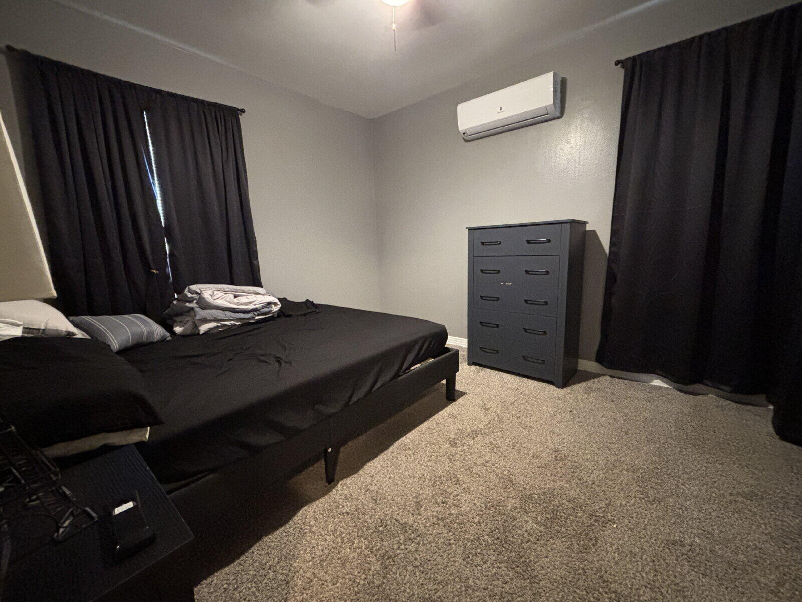 1808 14th Street, Unit 2 Lubbock, TX 79401 - Photo 8 of 8 a bedroom with a bed and a dresser