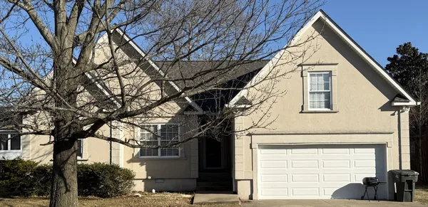 a view of a house with a large tree