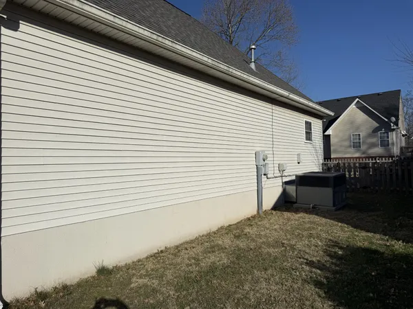a back view of a house with a yard