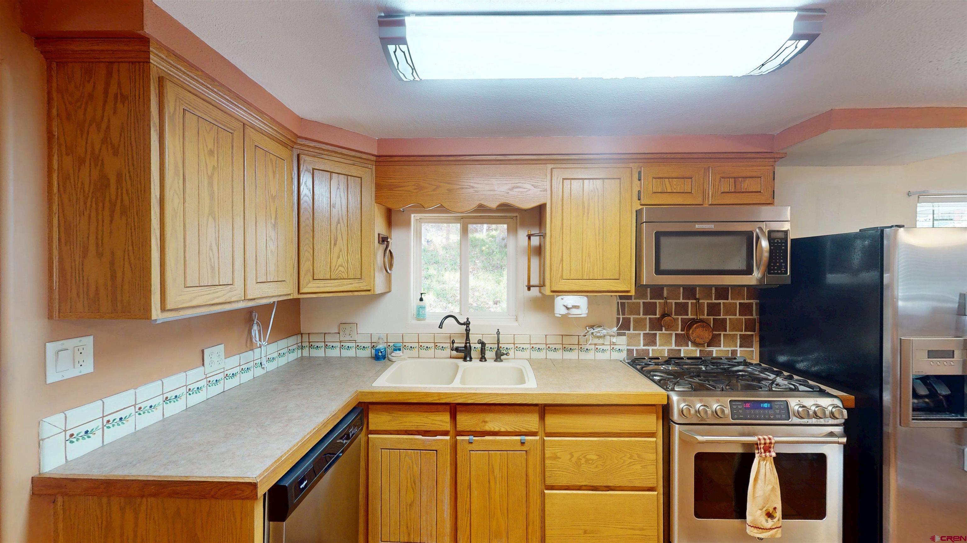 100 Rio Grande Avenue Paonia, CO 81428 - Photo 12 of 45 a kitchen with a sink stove and refrigerator
