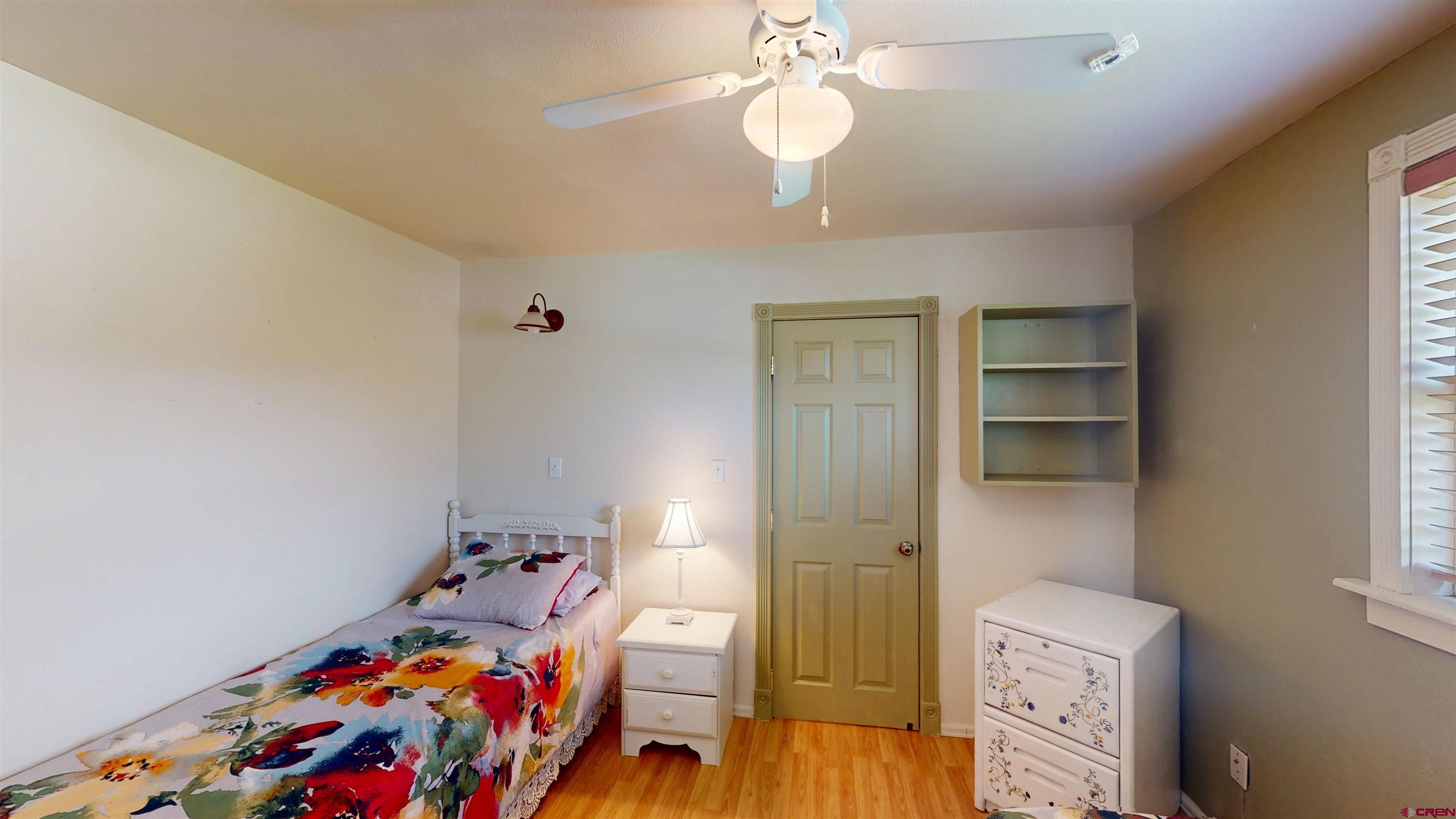100 Rio Grande Avenue Paonia, CO 81428 - Photo 26 of 45 a bedroom with a bed and wooden floor