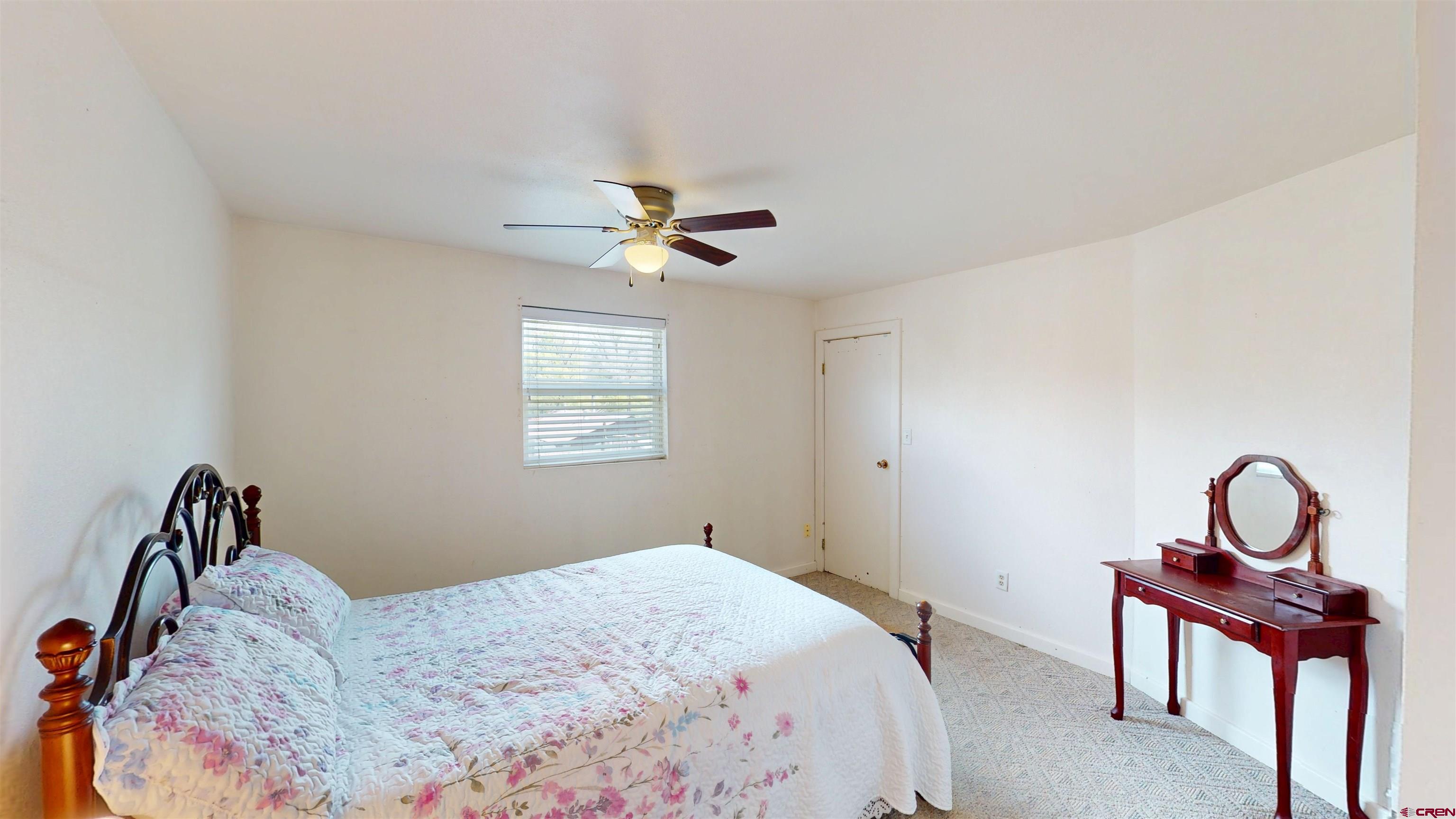 100 Rio Grande Avenue Paonia, CO 81428 - Photo 29 of 45 a bedroom with a bed and a chandelier