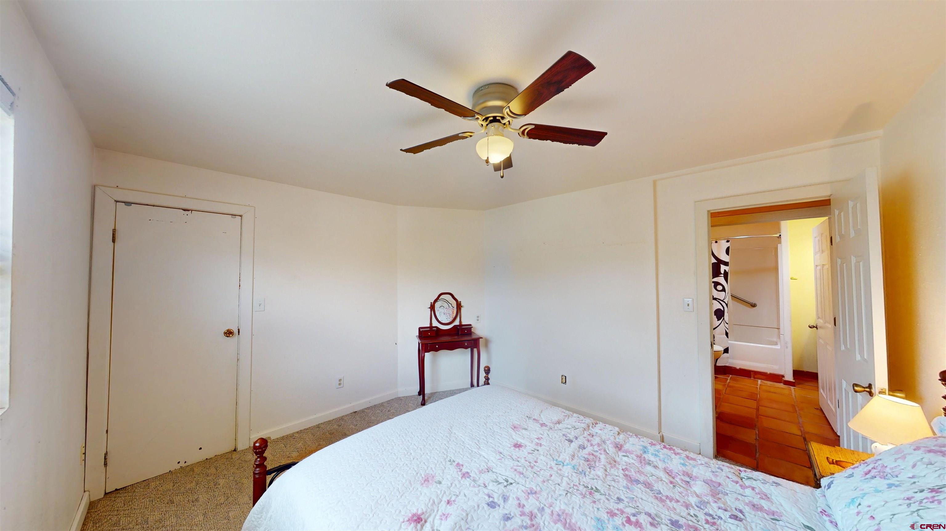 100 Rio Grande Avenue Paonia, CO 81428 - Photo 30 of 45 a bedroom with a bed and a chandelier