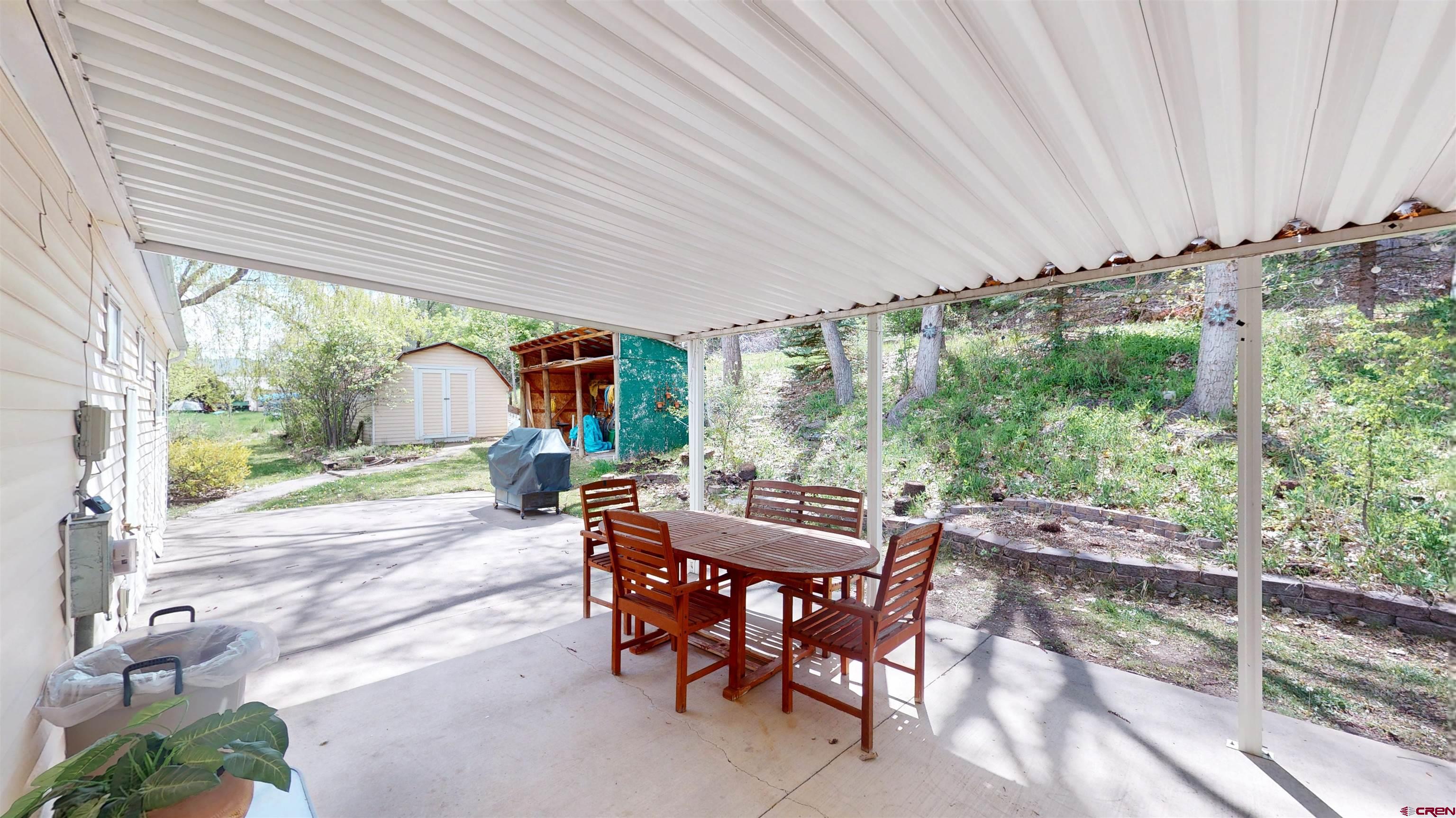 100 Rio Grande Avenue Paonia, CO 81428 - Photo 3 of 45 a view of a patio with table and chairs and potted plants