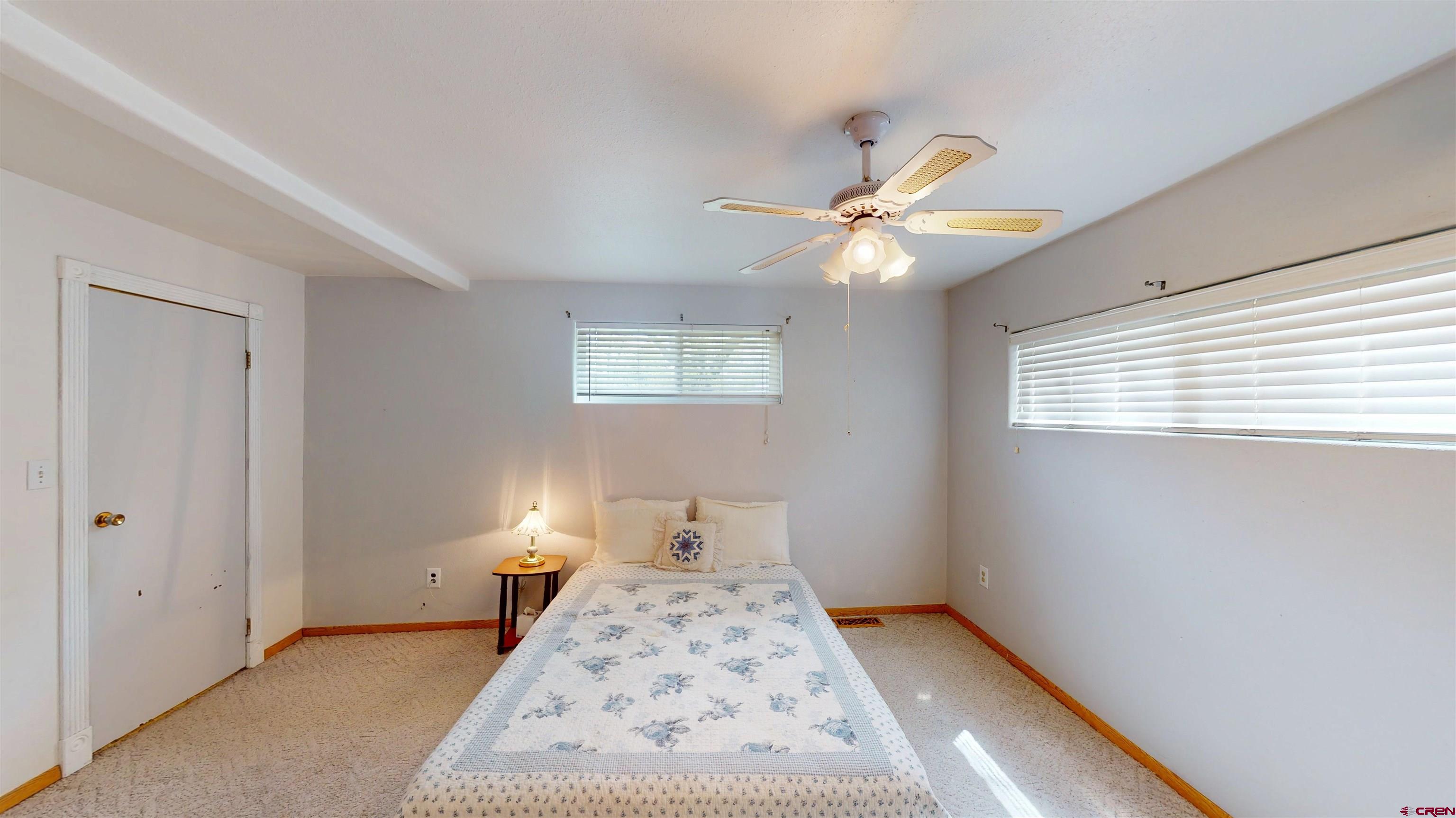 100 Rio Grande Avenue Paonia, CO 81428 - Photo 34 of 45 a bedroom with a bed and a chandelier