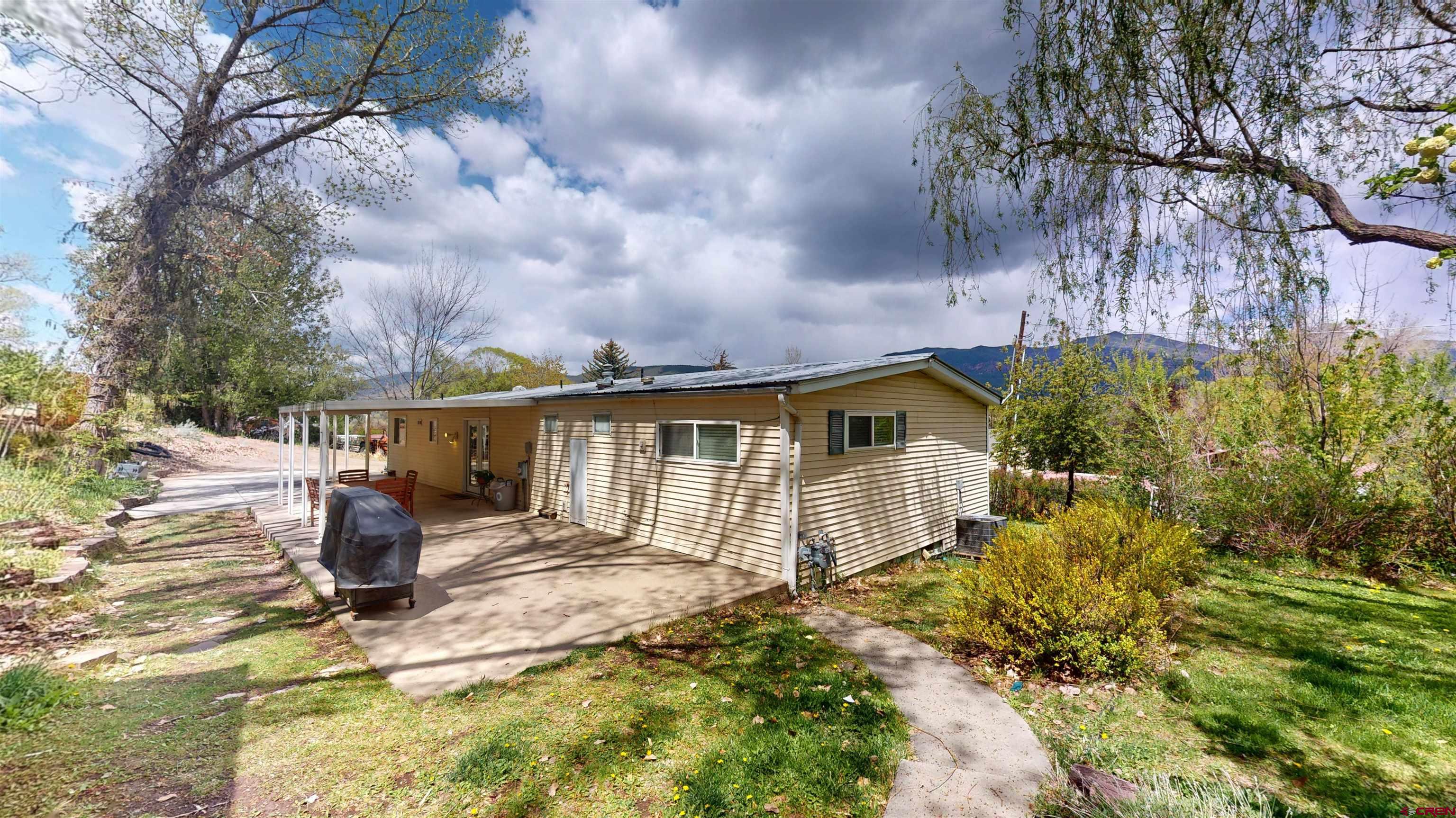 100 Rio Grande Avenue Paonia, CO 81428 - Photo 4 of 45 a front view of a house with garden