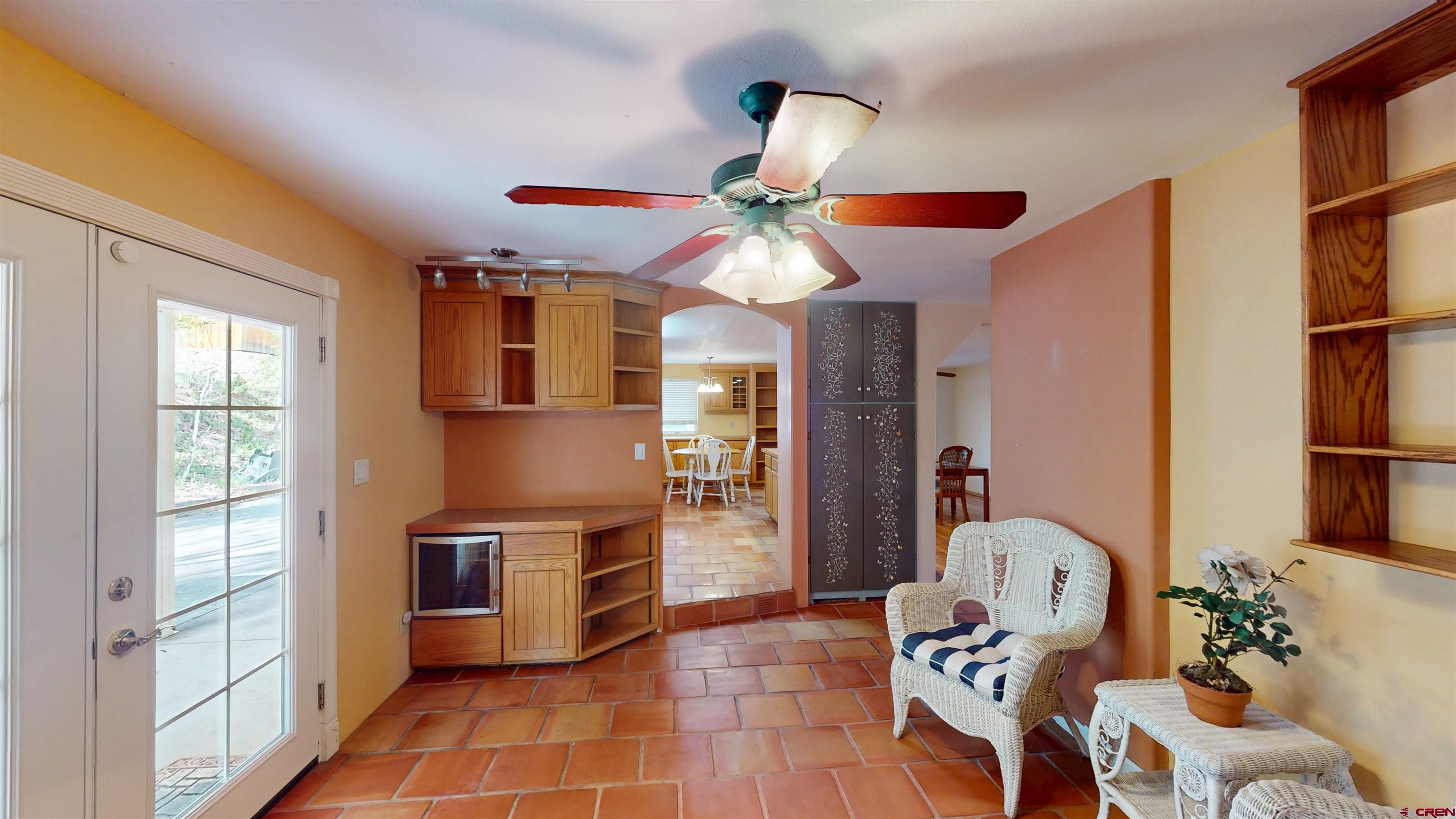100 Rio Grande Avenue Paonia, CO 81428 - Photo 10 of 45 a kitchen with stainless steel appliances kitchen island granite countertop a refrigerator a sink dishwasher a dining table and chairs with wooden floor