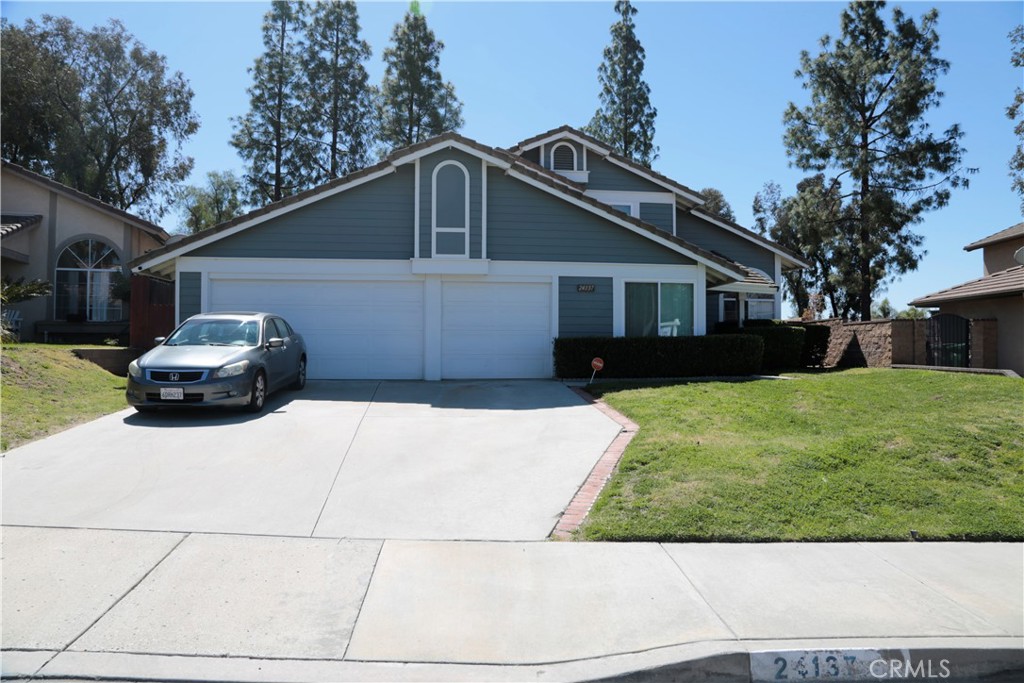 24137 Rimview Road Moreno Valley, CA 92557 - Photo 1 of 1 a front view of a house with a yard and garage