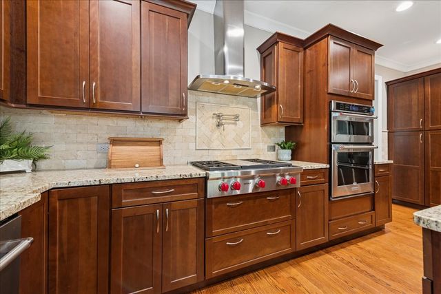 a kitchen with stainless steel appliances granite countertop a stove and a refrigerator