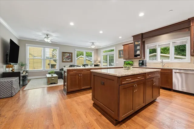 a kitchen with stainless steel appliances granite countertop a stove and a large refrigerator