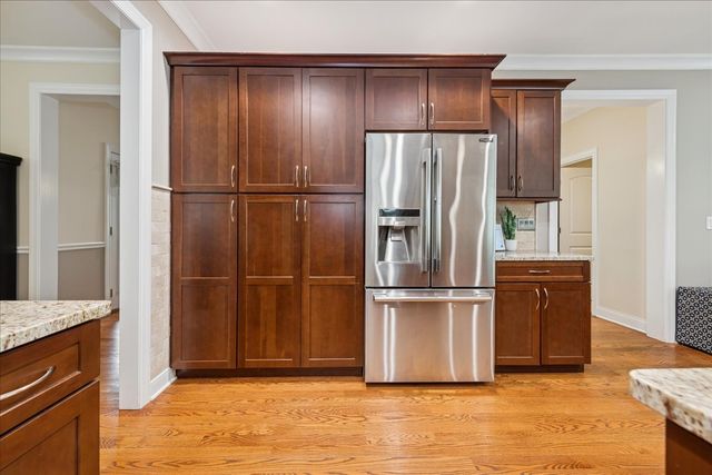 a kitchen with stainless steel appliances granite countertop a refrigerator and a sink