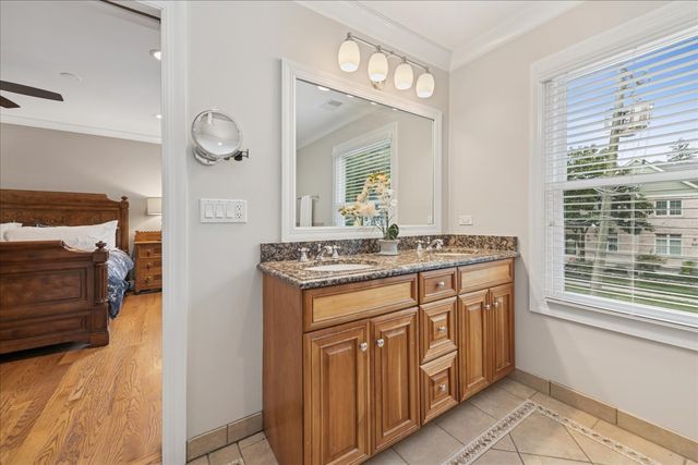 a bathroom with a sink a vanity and a large mirror