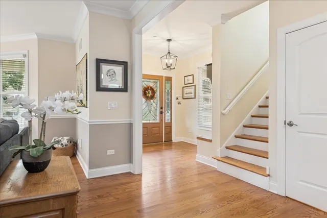 a view of a hallway with wooden floor and furniture
