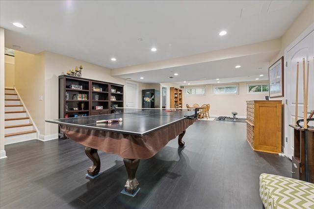 a living room with stainless steel appliances furniture and kitchen view