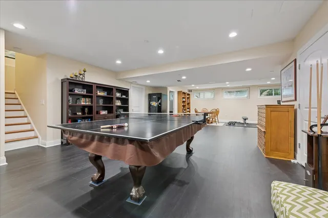 a living room with stainless steel appliances furniture and kitchen view