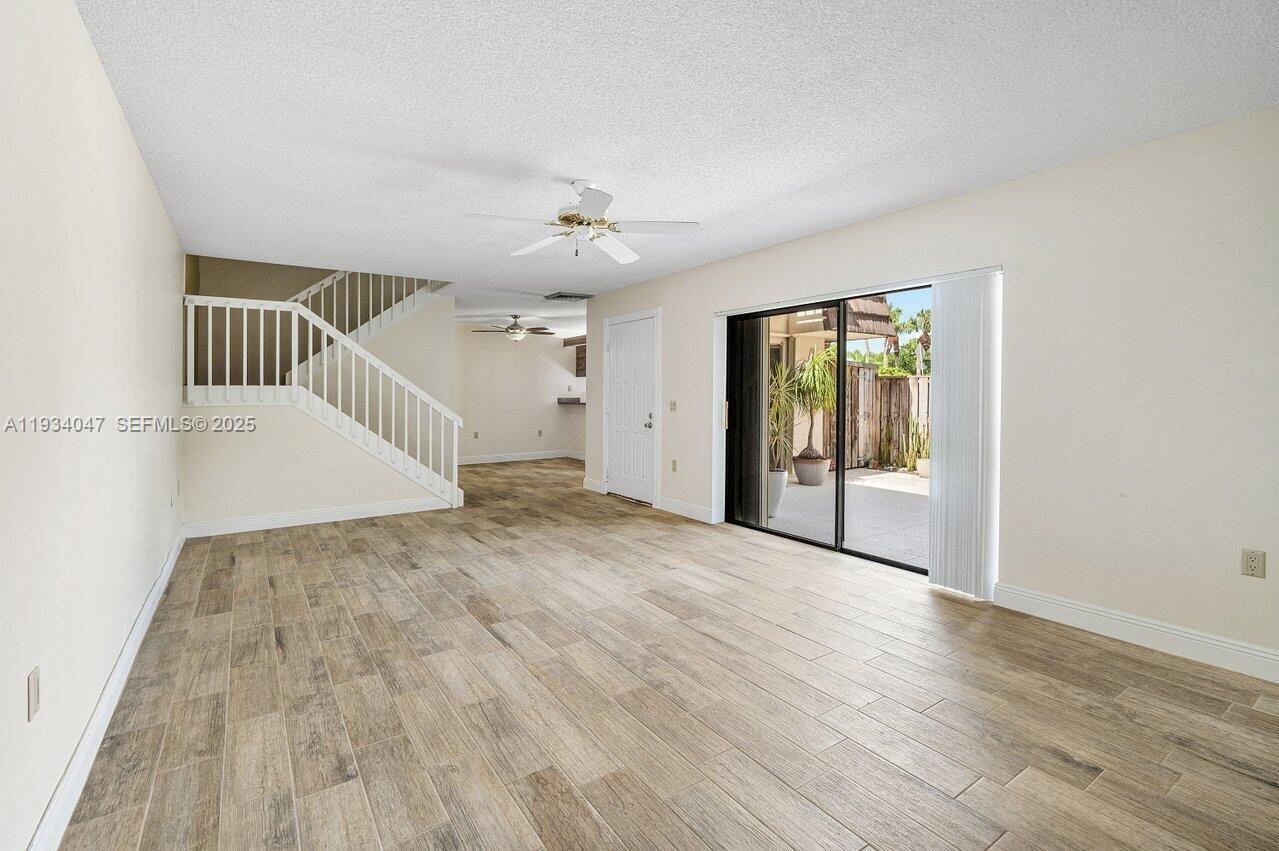 1619 16th Court Jupiter, FL 33477 - Photo 13 of 31 wooden floor in an empty room with a window