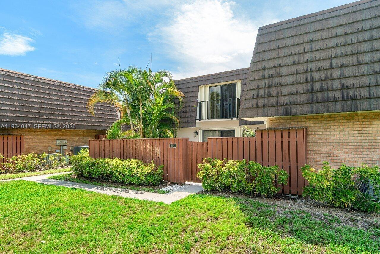 1619 16th Court Jupiter, FL 33477 - Photo 2 of 31 a house with a tree in front of it