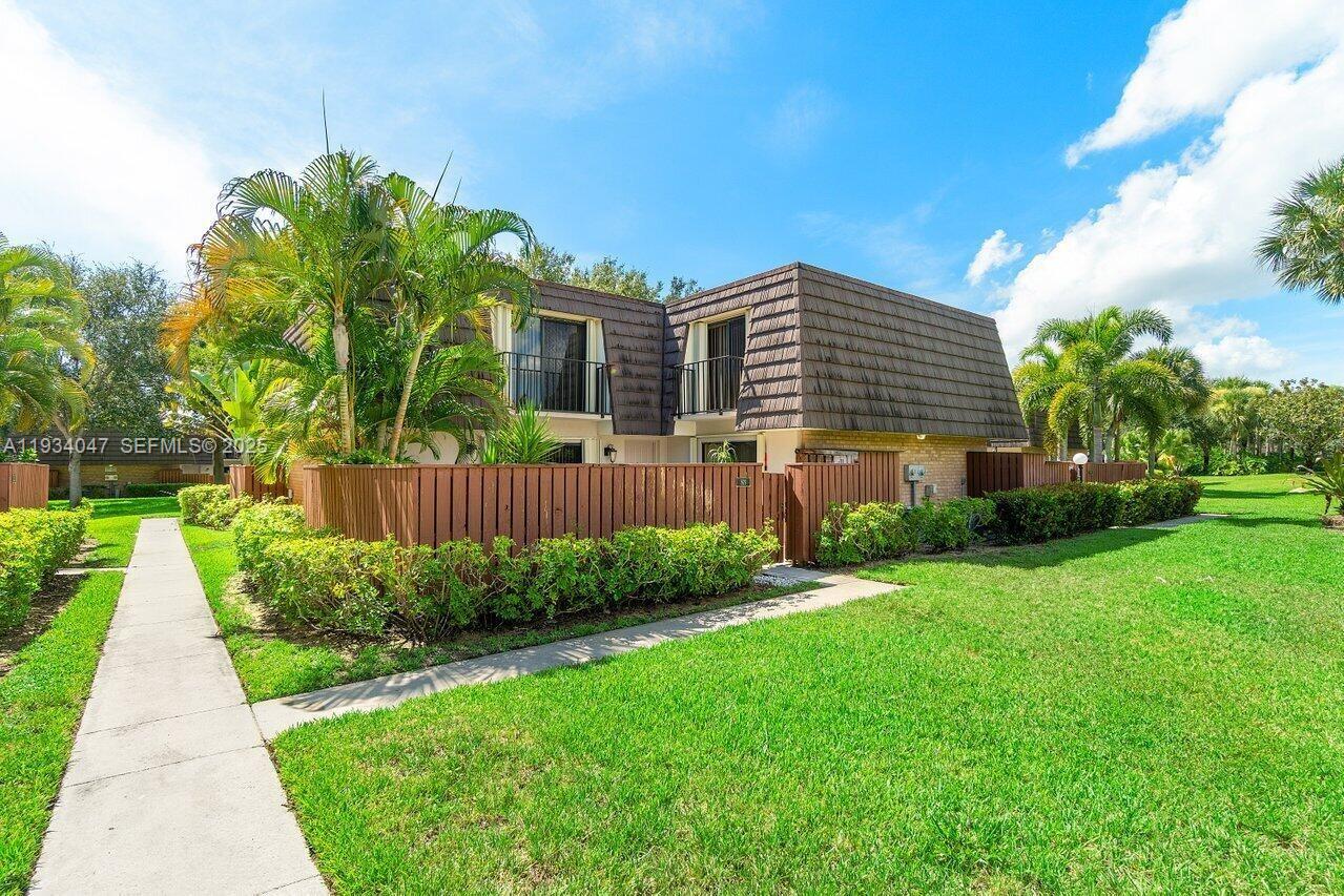 1619 16th Court Jupiter, FL 33477 - Photo 4 of 31 a front view of a house with a yard