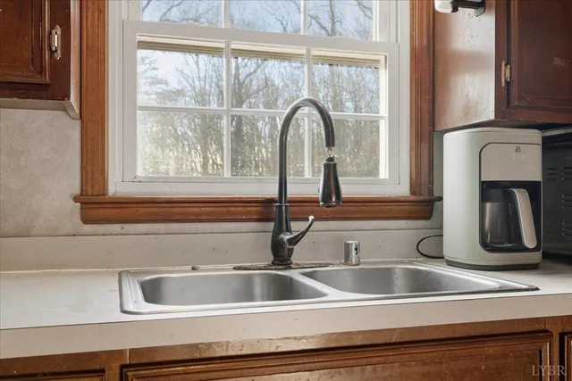 a bedroom with a bed a dresser and a window