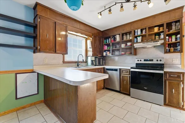 a kitchen with stainless steel appliances granite countertop a refrigerator and a stove top oven