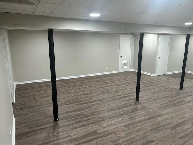 a living room with a fireplace and windows