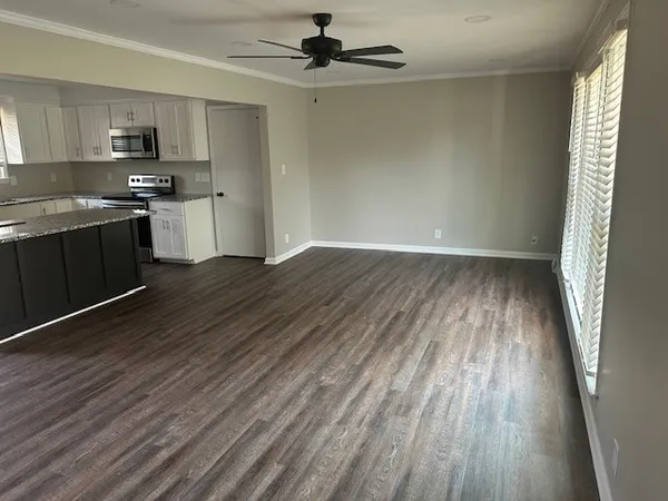 a kitchen with wooden floors and a fireplace