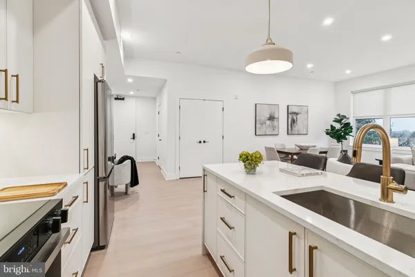 a kitchen with a sink appliances and a counter top space