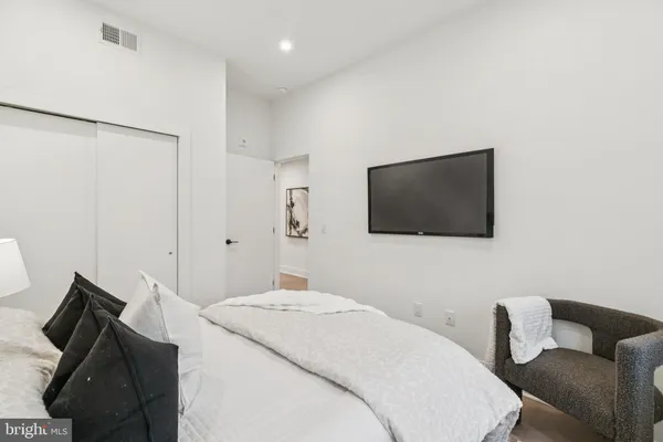a bedroom with a bed and a mirror