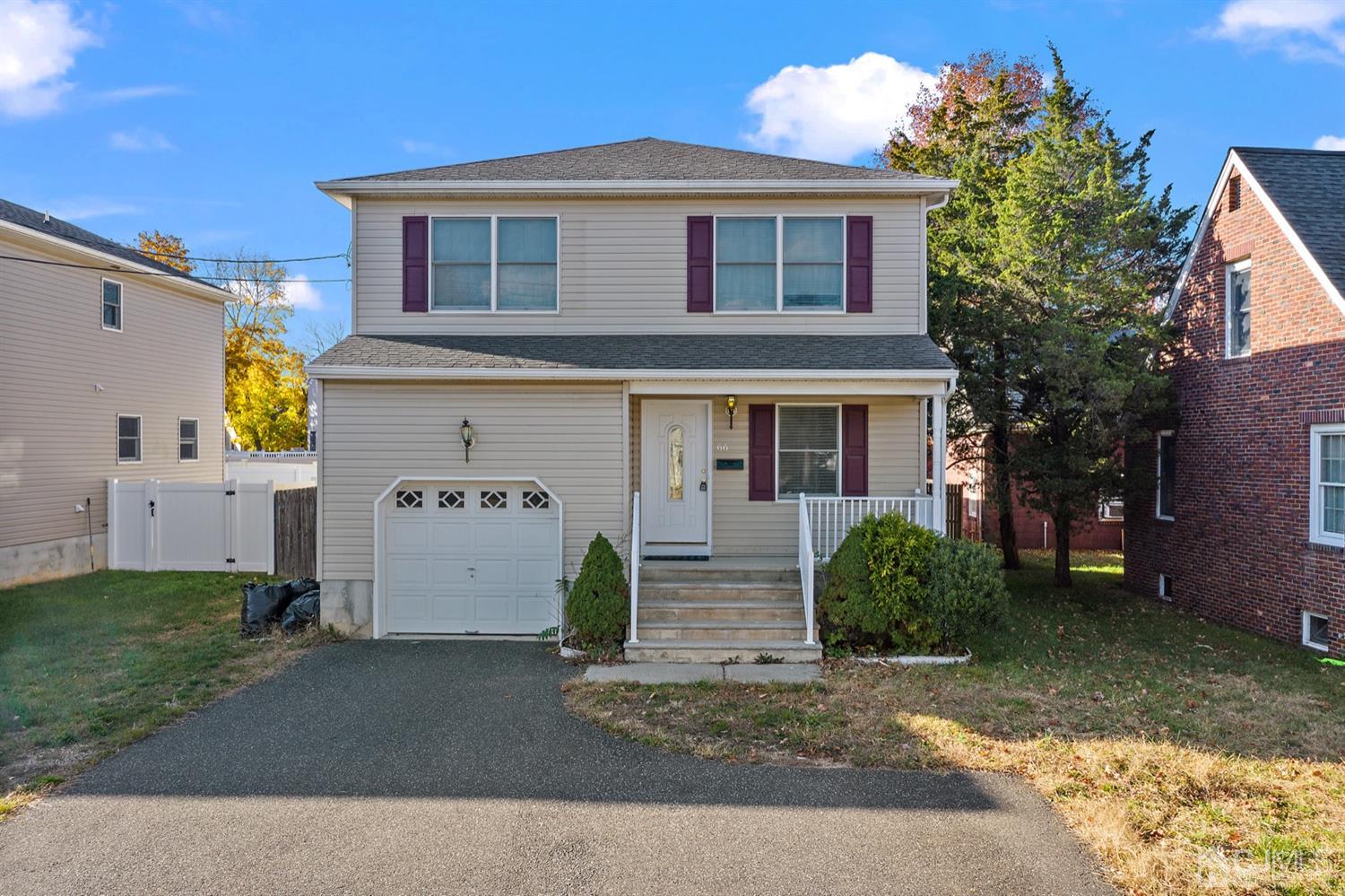 66 Helmetta Road Monroe Township, NJ 08831 - Photo 2 of 25 a front view of a house with a yard and garage