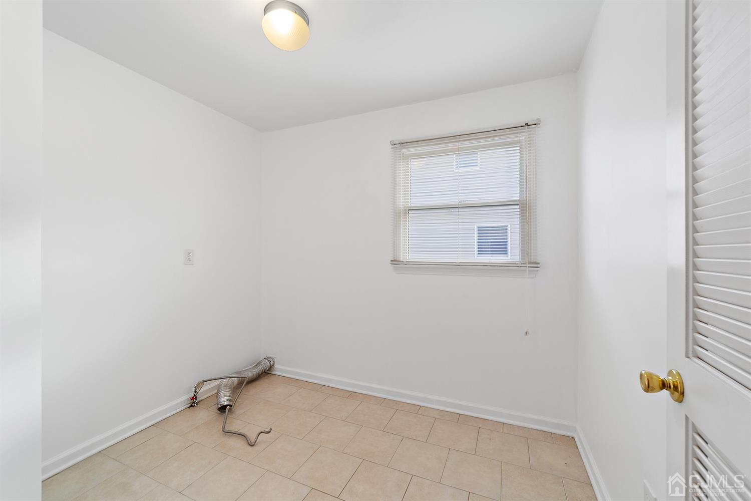 66 Helmetta Road Monroe Township, NJ 08831 - Photo 11 of 25 an empty room with a workbench