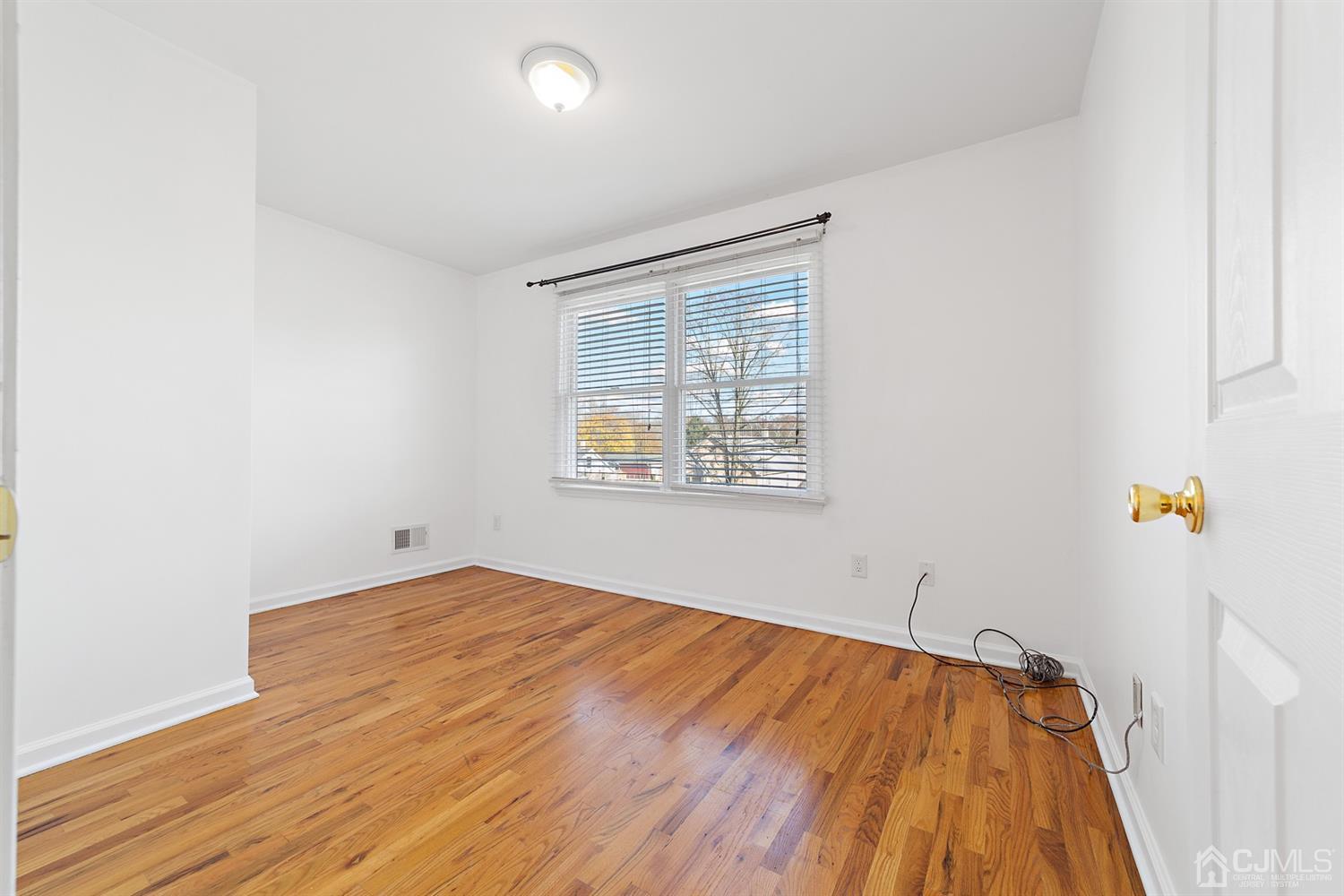 66 Helmetta Road Monroe Township, NJ 08831 - Photo 12 of 25 an empty room with wooden floor and windows