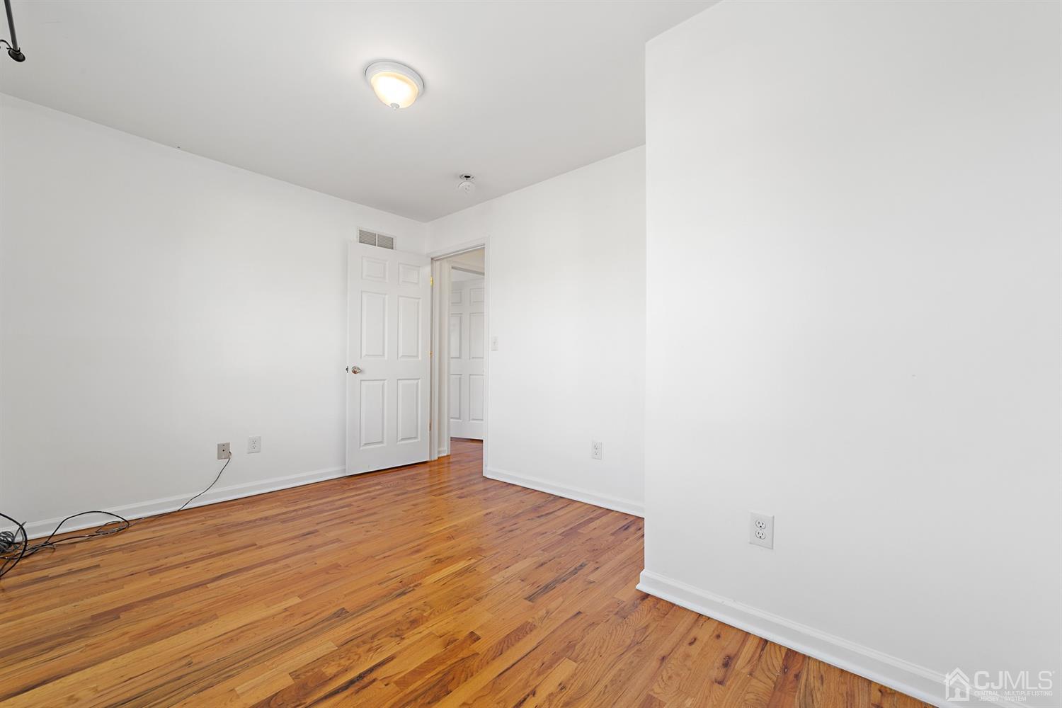 66 Helmetta Road Monroe Township, NJ 08831 - Photo 13 of 25 a view of empty room with wooden floor