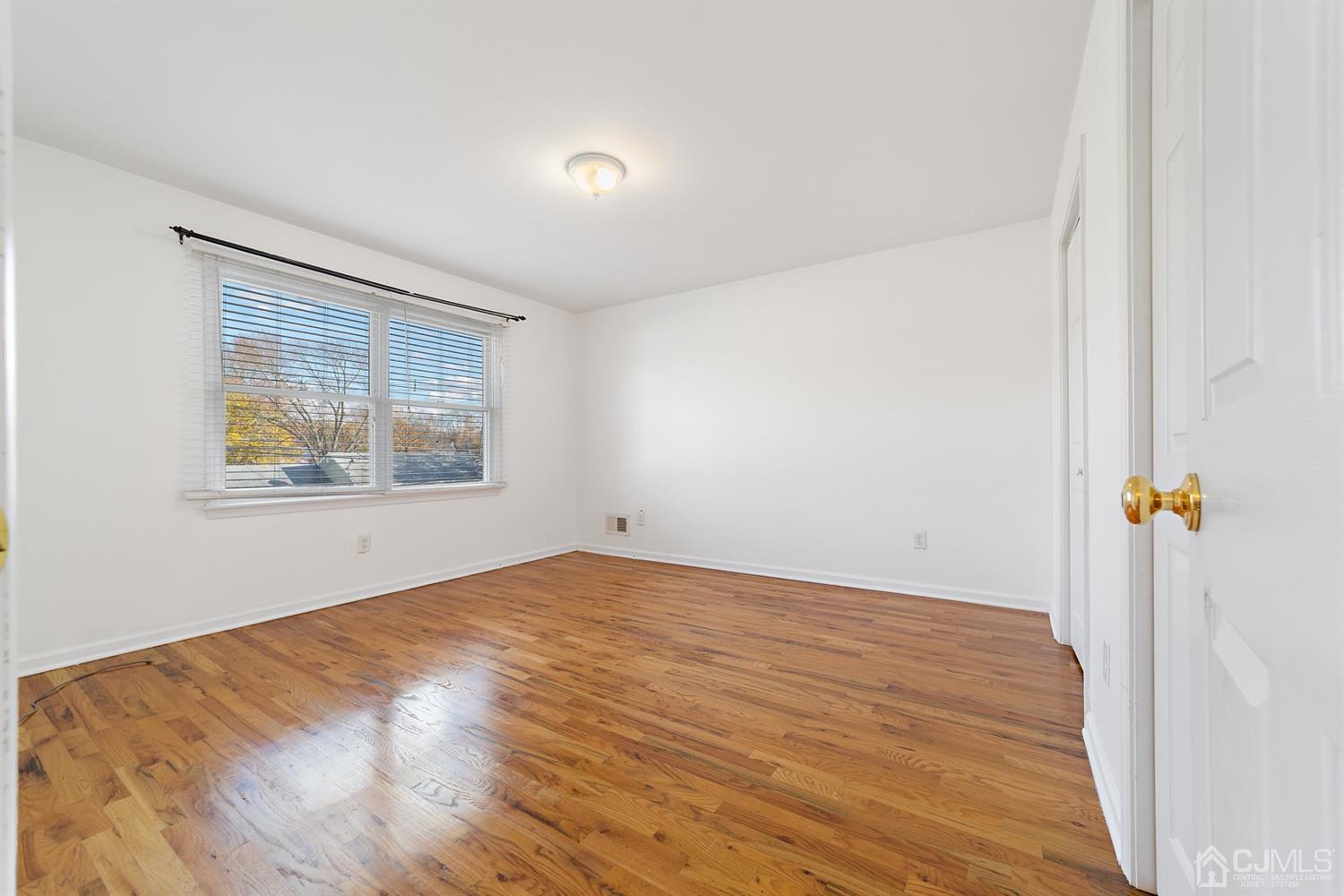 66 Helmetta Road Monroe Township, NJ 08831 - Photo 14 of 25 an empty room with wooden floor and window