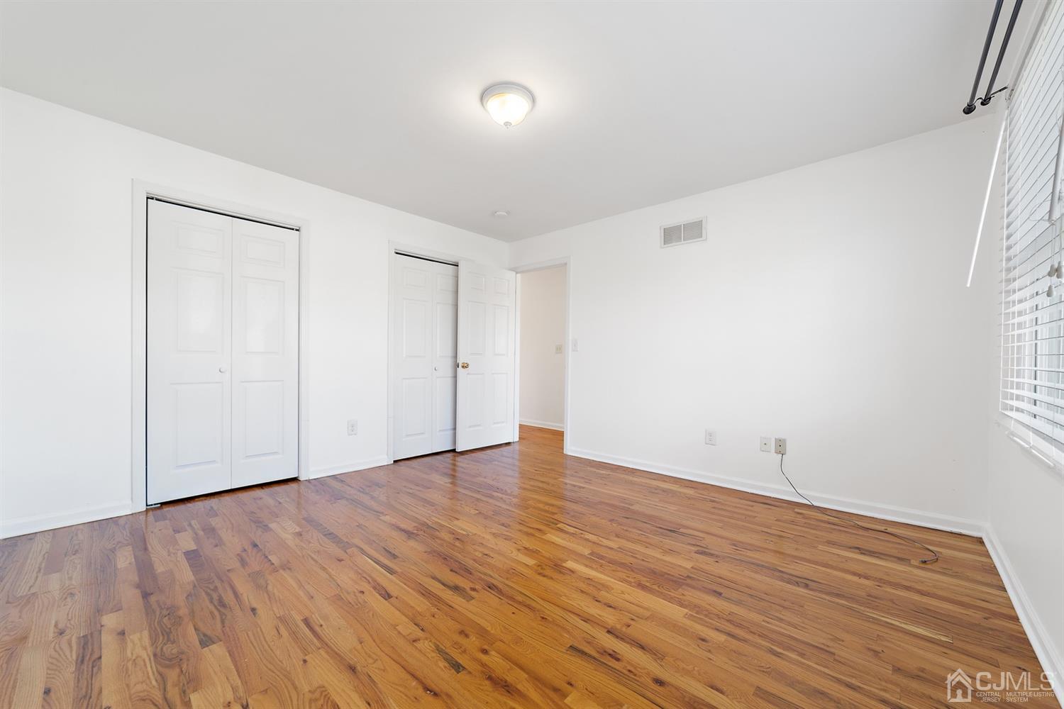 66 Helmetta Road Monroe Township, NJ 08831 - Photo 15 of 25 a view of an empty room with wooden floor and a window