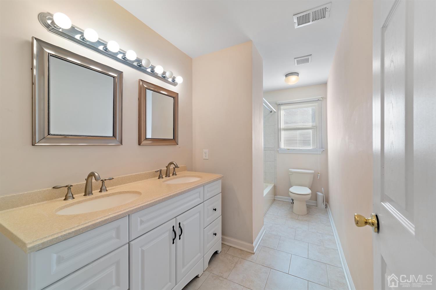 66 Helmetta Road Monroe Township, NJ 08831 - Photo 16 of 25 a bathroom with a toilet a sink and mirror