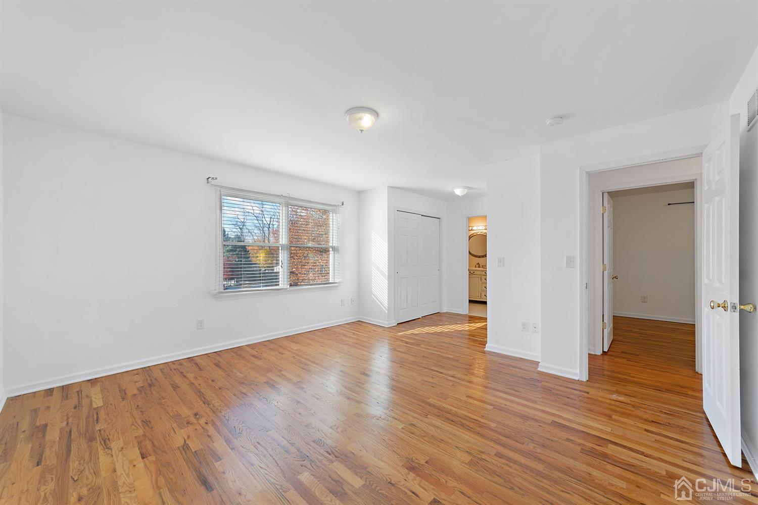 66 Helmetta Road Monroe Township, NJ 08831 - Photo 19 of 25 a view of an empty room with wooden floor and a window
