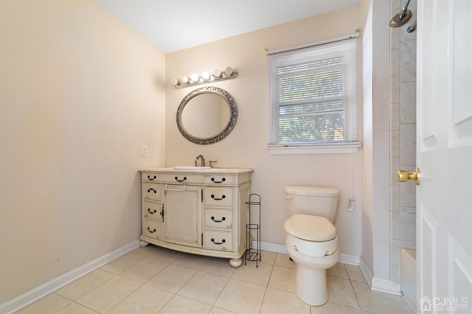 66 Helmetta Road Monroe Township, NJ 08831 - Photo 20 of 25 a bathroom with a toilet sink and mirror